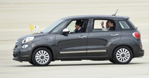 Pope Francis waves from inside a Fiat 500 as he leaves Andrews Air Force Base in Md., on Tuesday.