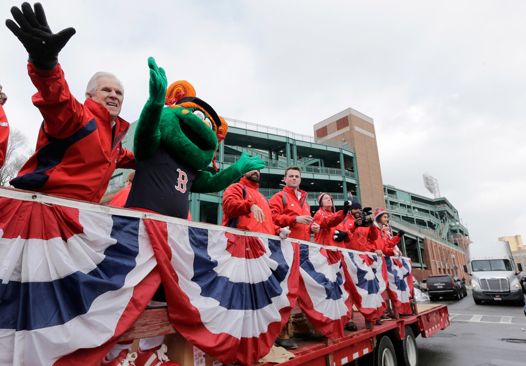 The Boston Red Sox new mascot Tessie the Green Monster rides on the back of a truck with team ambassadors leading the team's equipment truck as it departs Fenway Park in Boston on Wednesday en route to the team’s spring training baseball facility in Fort Myers, Fla. Boston pitchers and catchers will hold their first official workout on Feb. 19. The full team will have its first official workout on Feb. 24.