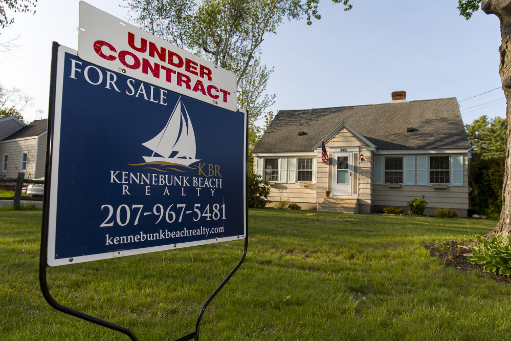 A sign announces that a house is under contract at 240 Ferry Road in Saco on Friday.  York County home sales for April jumped nearly 30 percent from a year ago – from 479 homes to 620 – while median price landed at $219,550.