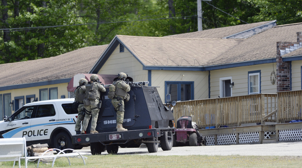 A tactical team from the Cumberland County Sheriff's Office takes position at the First and Last Motel in Bridgton during Thursday's standoff. Shawn Patrick Ouellette/Staff Photographer