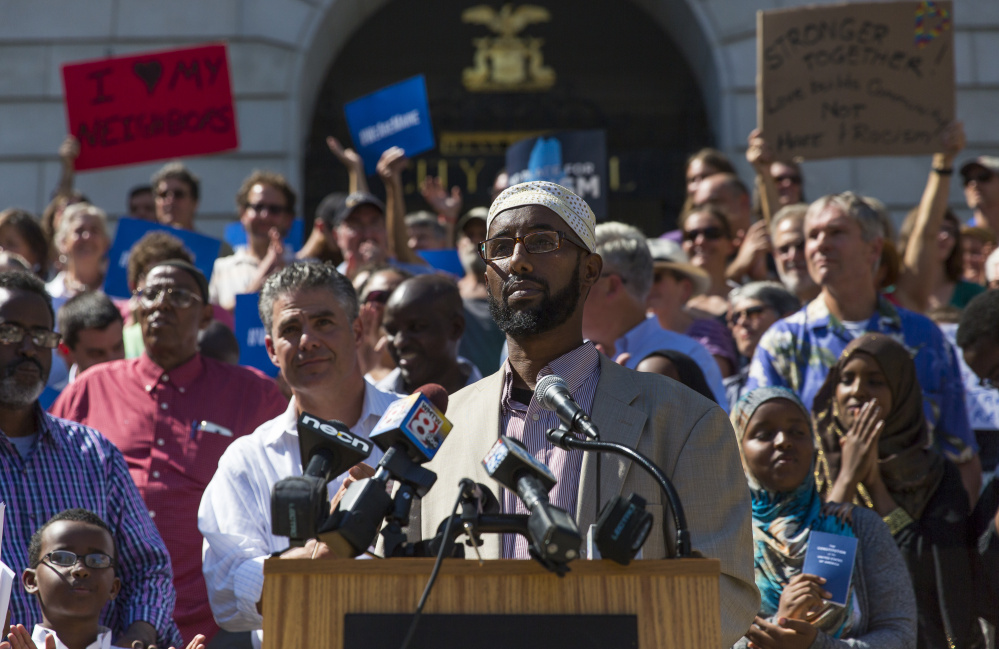 Mahmoud Hassan, president of the Somali Community Center of Maine, pauses for applause during a rally at Portland City Hall to protest Thursday's comments by Republican presidential nominee Donald Trump. Ben McCanna/Staff Photographer