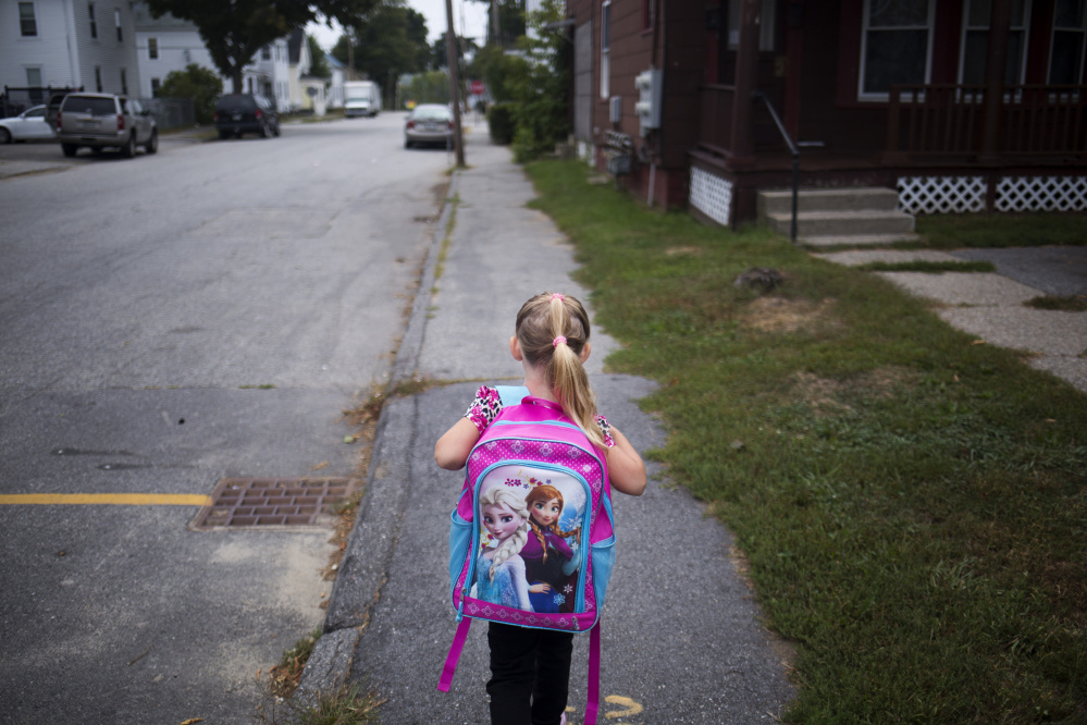 Arianna walks to school for her first day of kindergarten.
