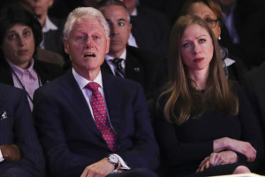 Former President Bill Clinton and Chelsea Clinton watch the debate.