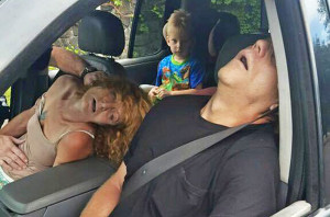The East Liverpool , Ohio, Police Department, posted this Sept. 7, 2016, photo of a young boy sitting in a vehicle behind his grandmother and her boyfriend, both of whom are unconscious from a drug overdose. Police photo via Associated Press