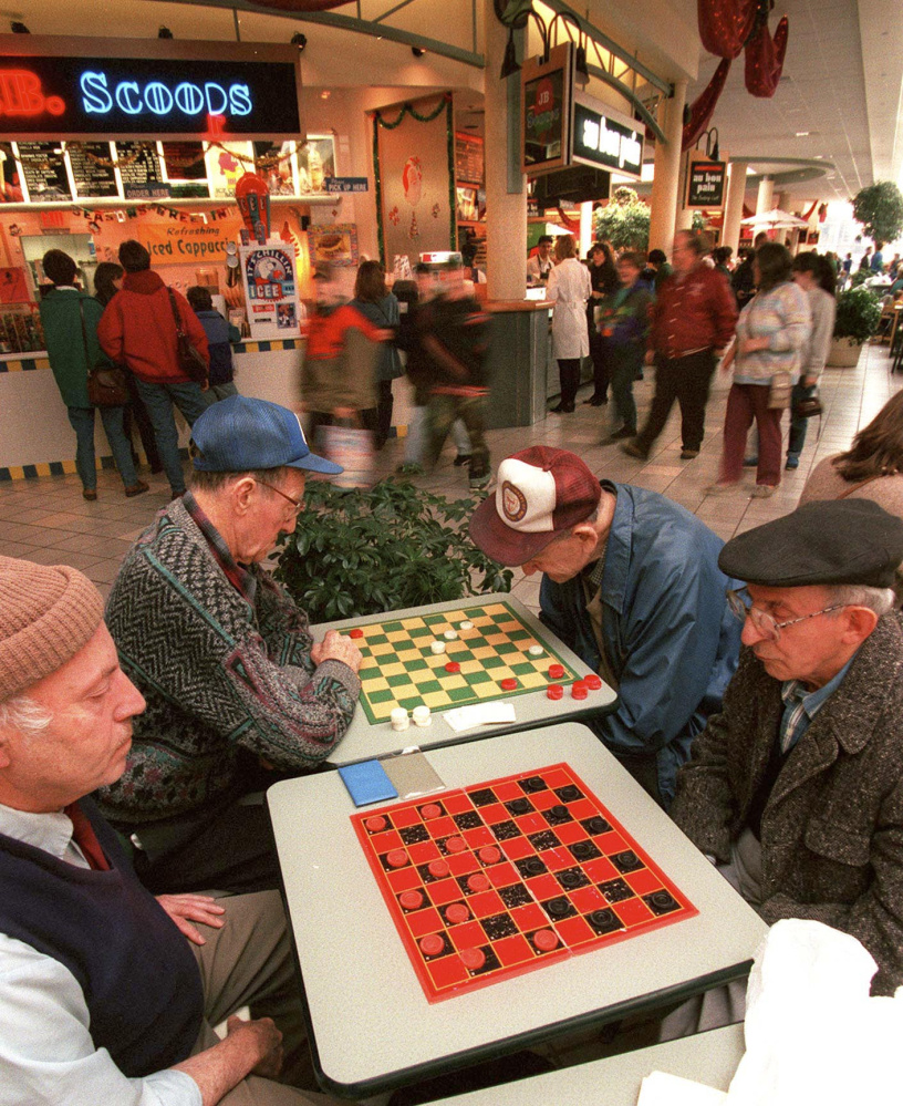 Saturday, November 23, 1996 -- (l-r) Warren Braverman, Rodney Scoville, Nate Cohen and Jim Bruni form an island of stillness among the early Saturday morning Maine Mall crowd as they gather for checkers.