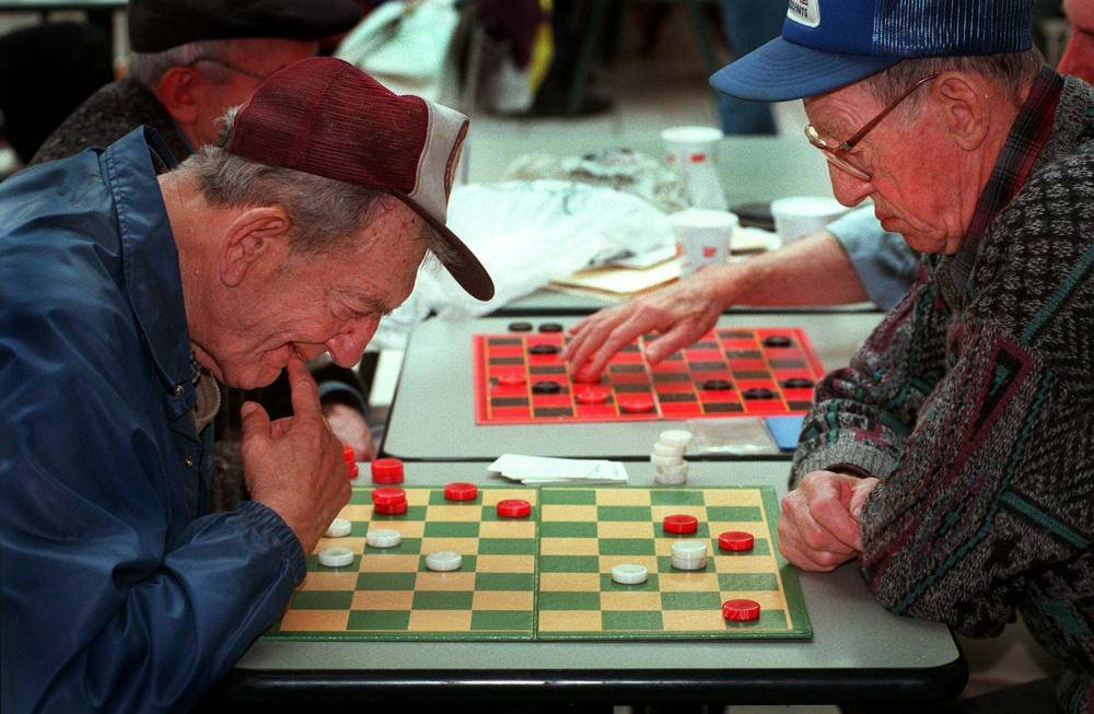Saturday, November 23, 1996 -- Nate Cohen and Rodney Scoville ponder their next moves as the two concentrate on their quiet game in the midst of shopper activity at the Maine Mall.