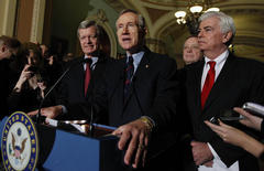 Senate Majority Leader Harry Reid of Nev., center, answers questions outside of the Senate chambers on Capitol Hill in Washington, Thursday, Dec. 24, 2009, after the Senate passed the health care reform bill. From left are, Senate Finance Finance Committee Chairman Sen. Max Baucus, D-Mont., Reid, Senate Majority Whip Richard Durbin of Ill., and Senate Banking Committee Chairman Sen. Christopher Dodd, D-Conn..