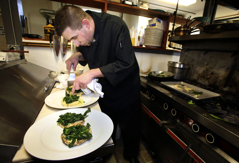 Paul Dyer, executive chef at the Porthole, prepares eggs Florentine, which is “probably our number one-selling dish right now on our menu,” he said.