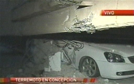 In this image provided by TVN a crushed car can be seen in a parking garage in Concepcion, Chile, following the earthquake early this morning.