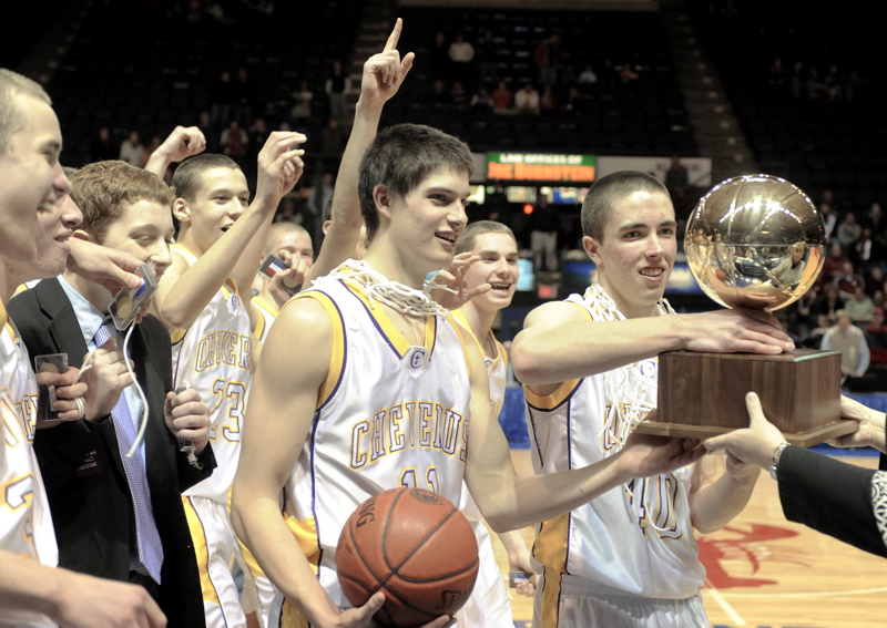 Indiana Faithfull, left, and Kyle Randall of Cheverus receive the Gold Ball after the Stags defeated Edward Little 55-50 in the Class A state final at the Cumberland County Civic Center.
