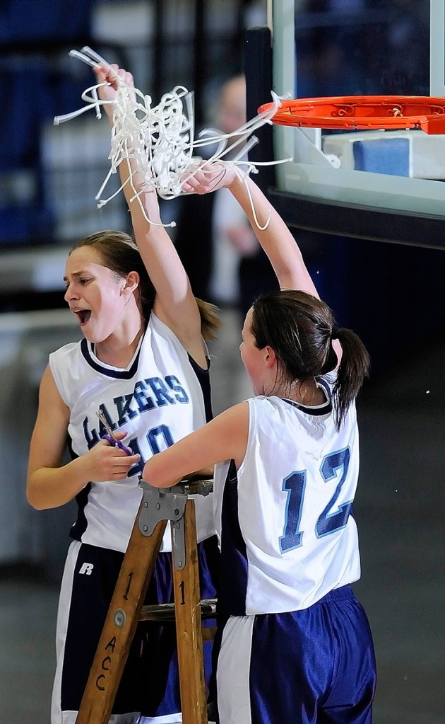 Gretel Breton, left, and Miranda Drinkwater cut down the net after their team's 46-29 victory over Rangeley in the Western Class D girls' basketball championship game at the Augusta Civic Center.