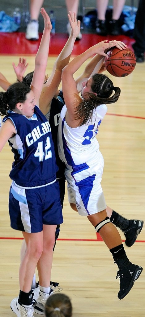 Madison's Andrea Smith gets fouled while trying to shoot over Calais defenders Brook Young, left, and Nicole Osborne.