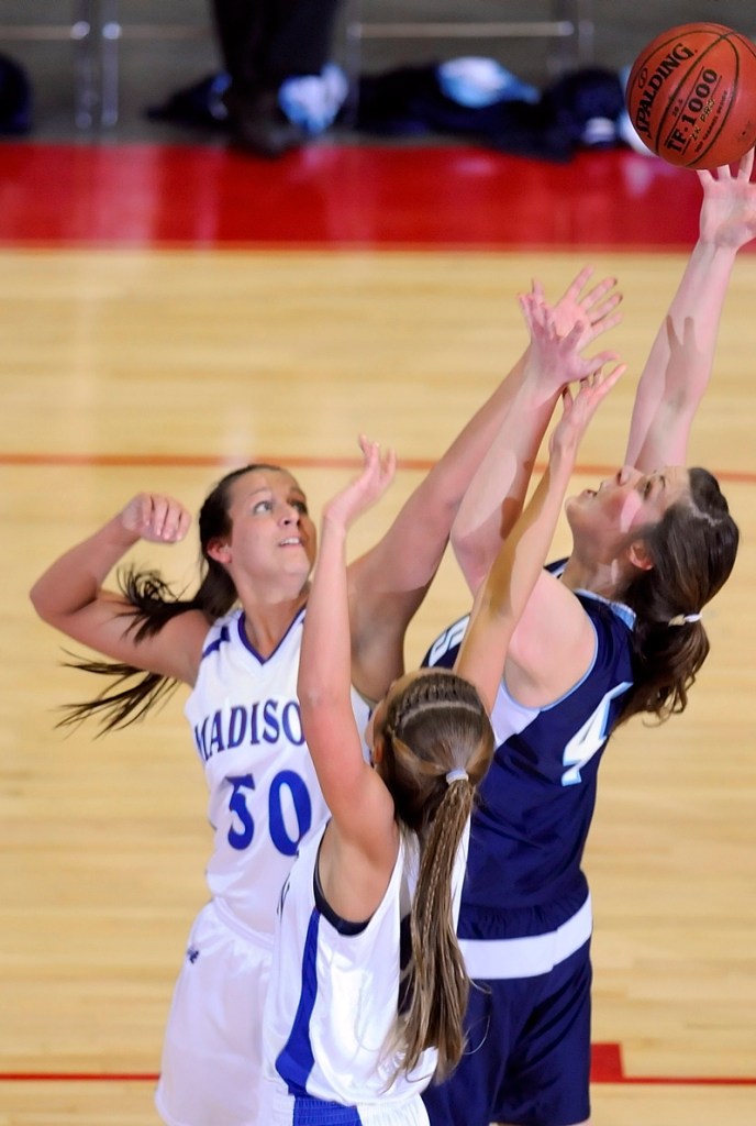 Andrea Smith, left, and Alexandra Russell of Madison battle for a rebound with Nicole Osborne.