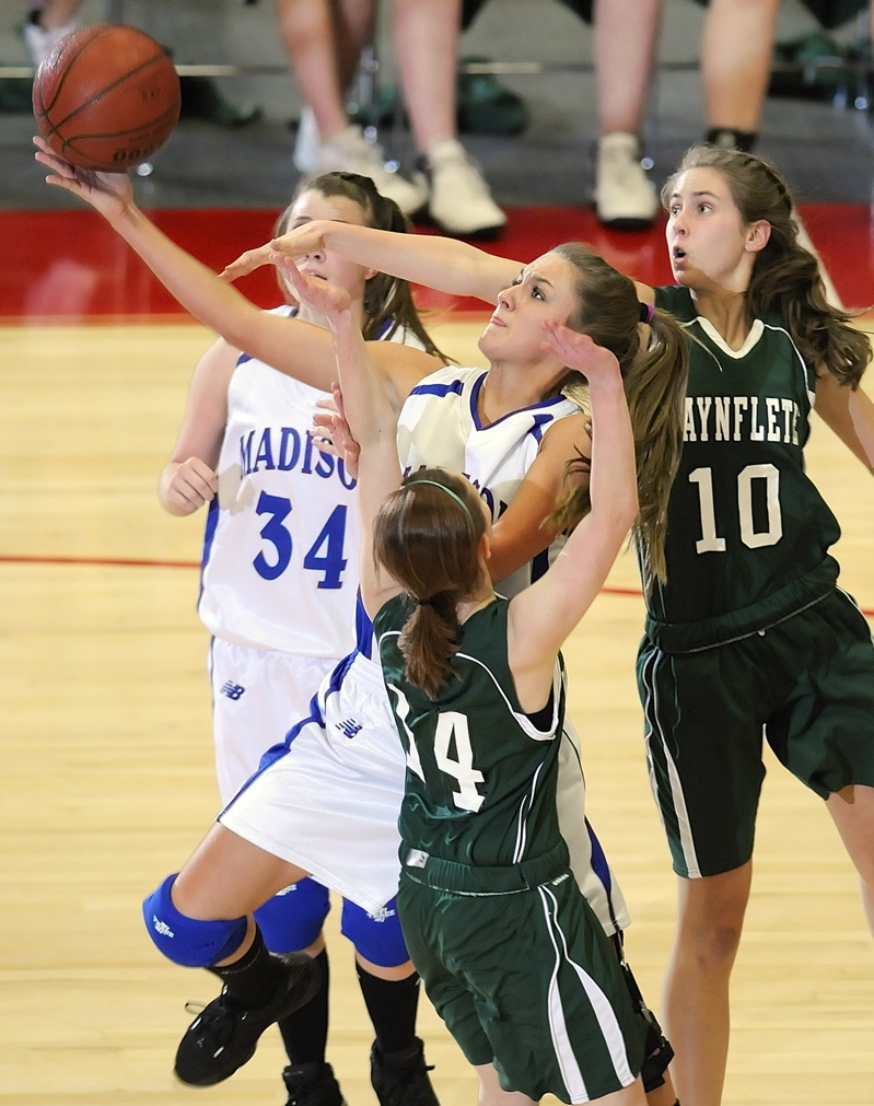 Ali Russell goes up for a shot under pressure from Waynflete defenders Sophie Richards-Connolly, left, and Lydia Stegemann.