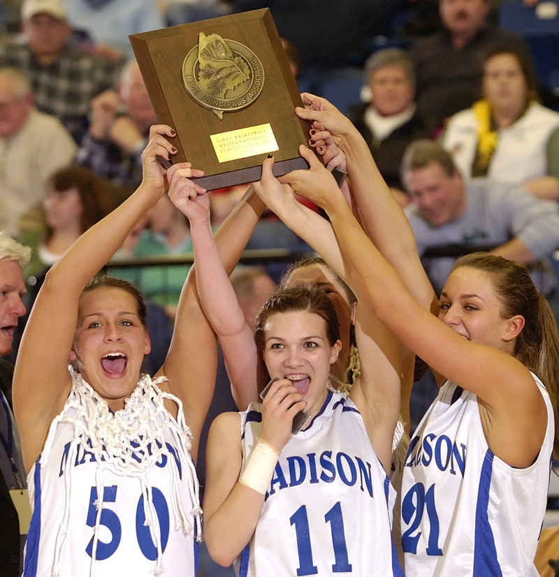 Andrea Smith, left, Marlisa Emerson and Alexandra Russell hold up the championship plaque after Madison beat Waynflete 37-23 in the Western Class C final at the Augusta Civic Center.