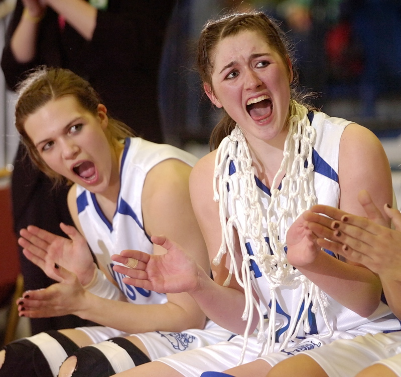 Marlisa Emerson, left, and Bianca Stoutamyer cheers while teammmates get their medals after the game.