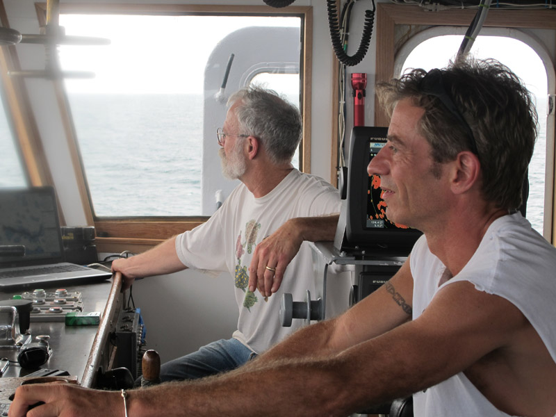 Captain Gary Esper of Hopkinton, Mass., right, and volunteer Shipmaster Kevin Garthwaite of Wells guide the Sea Hunter to its anchorage this morning off the Haitian port of Les Cayes.