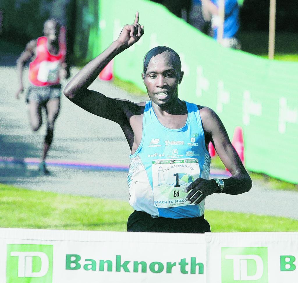 Ed Muge, 26, of Kenya is first across the finish line in the 2009 Beach to Beacon 10K race. One participant says a new system for picking entrants is flawed.