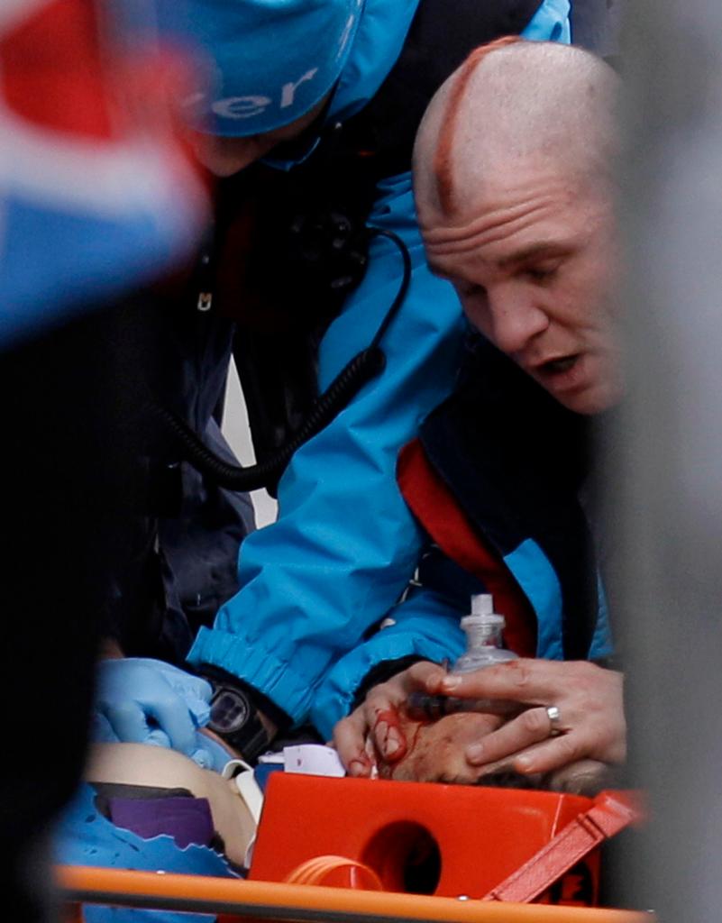 Nodar Kumaritashvili of Georgia is seen being given chest compressions and mouth-to-mouth resuscitation after crashing during a training run for the men's singles luge at the Vancouver 2010 Olympics in Whistler, British Columbia, Friday, Feb. 12, 2010. (AP Photo/Michael Sohn)