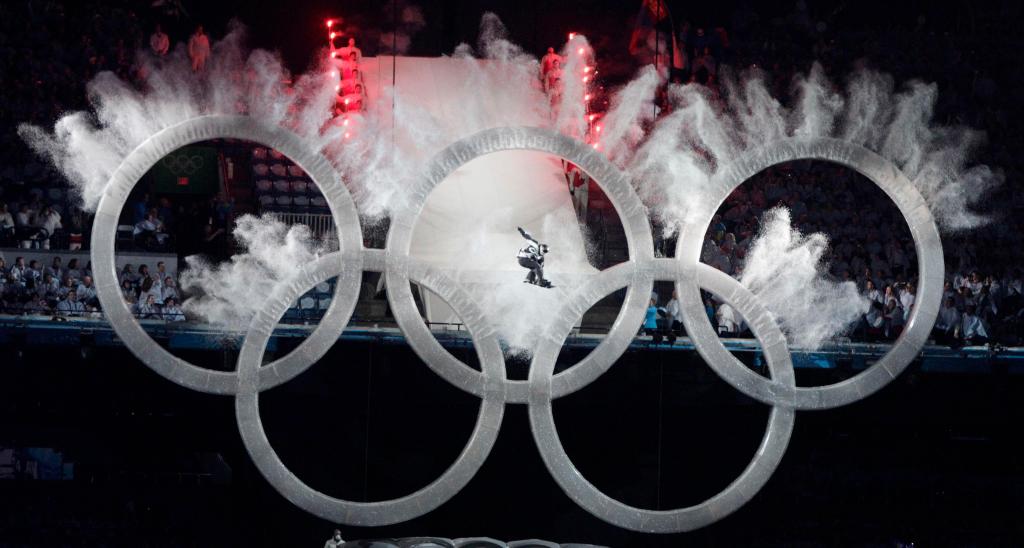 A snowboarder sails through the Olympic rings during the opening ceremony for the Vancouver 2010 Olympics in Vancouver, British Columbia, Friday, Feb. 12, 2010. (AP Photo/Amy Sancetta)