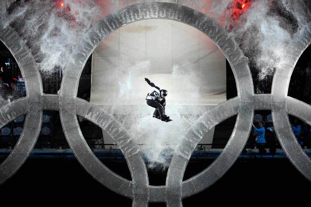 A snowboarder jumps through the Olympic rings during the opening ceremony for the Vancouver 2010 Olympics in Vancouver, British Columbia, Friday, Feb. 12, 2010. (AP Photo/Mark J. Terrill)