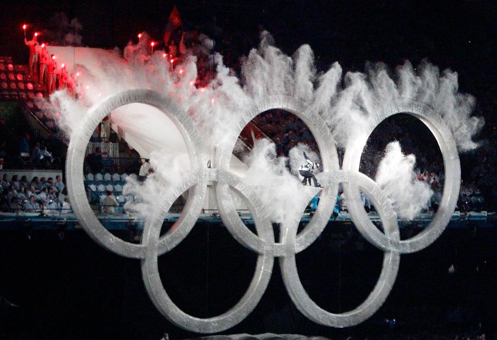 A snowboarder sails through the Olympic rings during the opening ceremony for the Vancouver 2010 Olympics in Vancouver, British Columbia, Friday, Feb. 12, 2010. (AP Photo/Charlie Riedel)