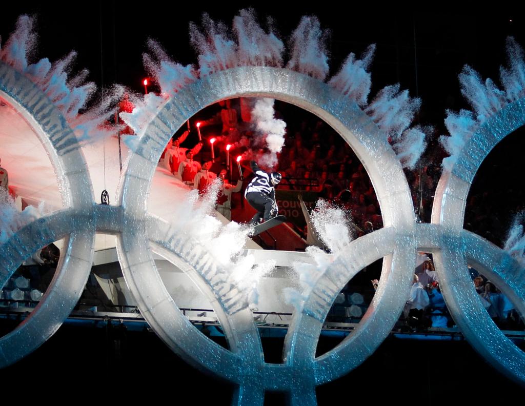A snowboarder sails through the Olympic rings during the opening ceremony for the Vancouver 2010 Olympics in Vancouver, British Columbia, Friday, Feb. 12, 2010. (AP Photo/Mark Baker)