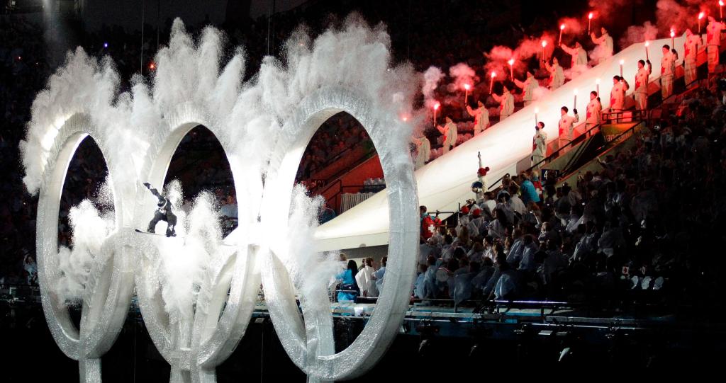A snowboarder jumps through the Olympic rings during the opening ceremony for the Vancouver 2010 Olympics in Vancouver, British Columbia, Friday, Feb. 12, 2010.(AP Photo/David J. Phillip)