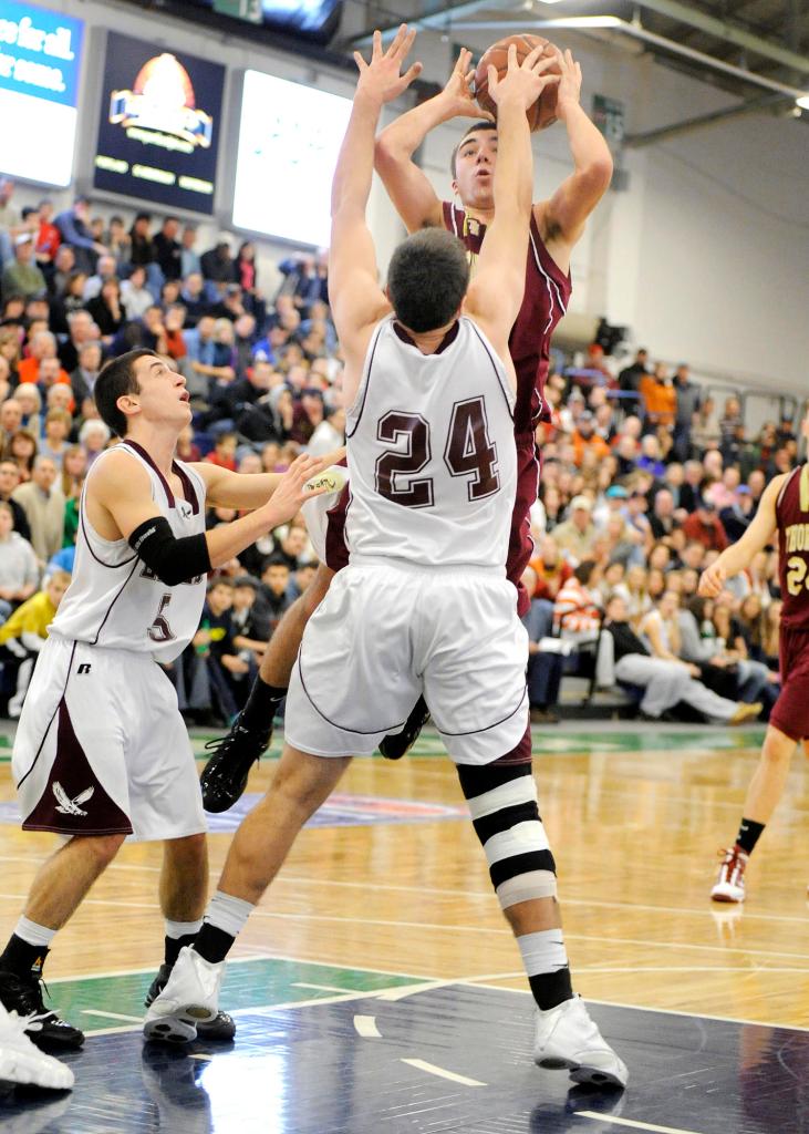 Photo by John Ewing/Staff Photographer... Friday, February 12, 2010...Windham vs. Thornton Academy boys basketball tournament game at the Expo. Windham's #24, Nick Taylor, blocks a jumpshot by Thornton's Corbett Smith.