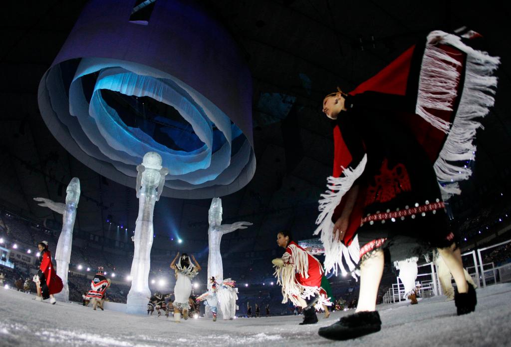 Aboriginal people of Canada dance around Welcoming Poles during the opening ceremony for the Vancouver 2010 Olympics in Vancouver, British Columbia, Friday, Feb. 12, 2010. (AP Photo/Gerry Broome)