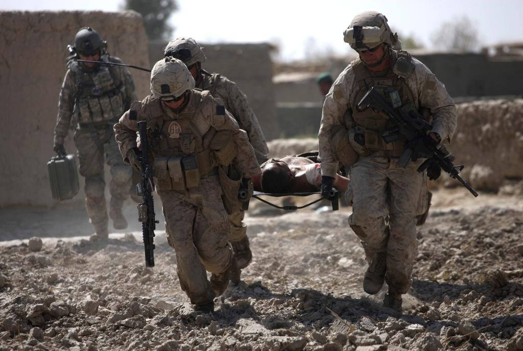 U.S. Marines carry a wounded Afghan National Army soldier to a waiting U.S. Army Task Force Pegasus medevac helicopter, in Marjah, Helmand province, Afghanistan, Wednesday Feb. 17, 2010. Pegasus aeromedical crews have been attacked regularly over the past days while evacuating the wounded as U.S. and Afghan troops take part in an assault in the Taliban stronghold of Marjah. (AP Photo/Brennan Linsley)
