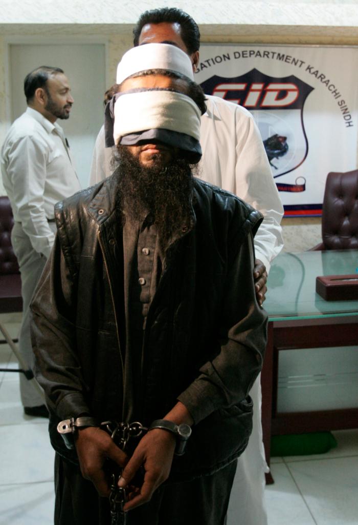 An alleged Taliban commander Abdullah alias Abu Waqas is presented before the media in Karachi, Pakistan Wednesday, Feb. 17, 2010. According to police officials Abdullah is involved in recruiting female suicide bombersand was arrested in Karachi while he was planning terrorist activates in the city. Pakistan on Wednesday confirmed the Afghan Taliban's No. 2 leader commander, Mullah Abdul Ghani Baradar, had been captured also. (AP Photo/Shakil Adil)