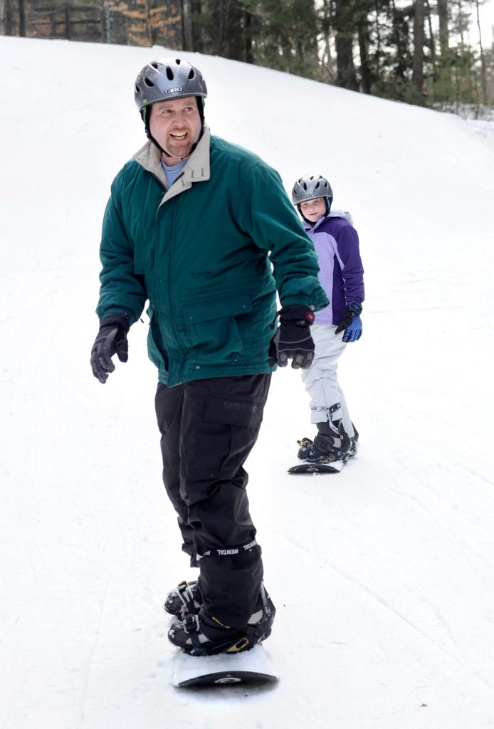 Drew Sachs and daughter Deidre try boarding. Sachs says he and his wife, Melanie, “both turned 40 this year and we said, ‘This is the year we try new things.’ ”