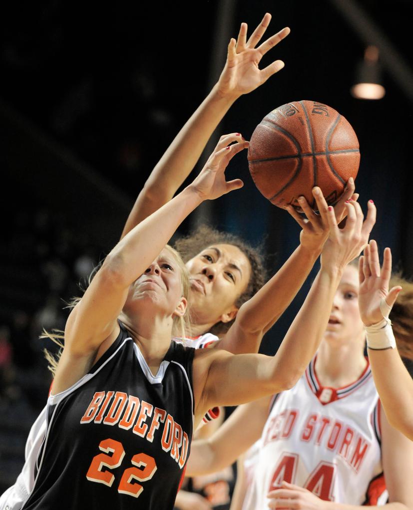 Photo by John Ewing/staff photographer... Friday, February 19, 2010....Scarborough vs. Biddeford girls class A semi-final basketball game. Biddeford's #22, Amethyst Hersom fights for a rebound with Scarborough's Carly Rogers.