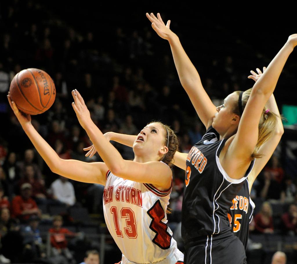 Photo by John Ewing/staff photographer... Friday, February 19, 2010....Scarborough vs. Biddeford girls class A semi-final basketball game. Scarborough's #13, Ellie Morin drives to the basket in front of Biddeford's Keila Grigware.