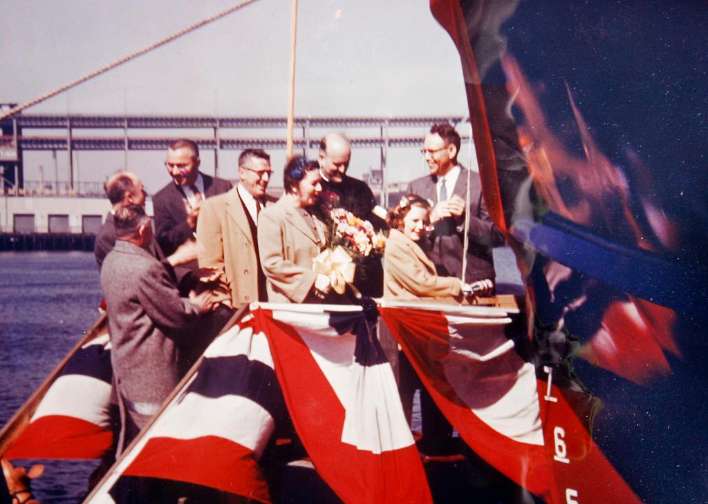 Deborah Gray christens the City of Portland III fireboat in East Boston on March 20, 1959, when she was 10 years old. Behind her, in the beige coats, are her mother and father.