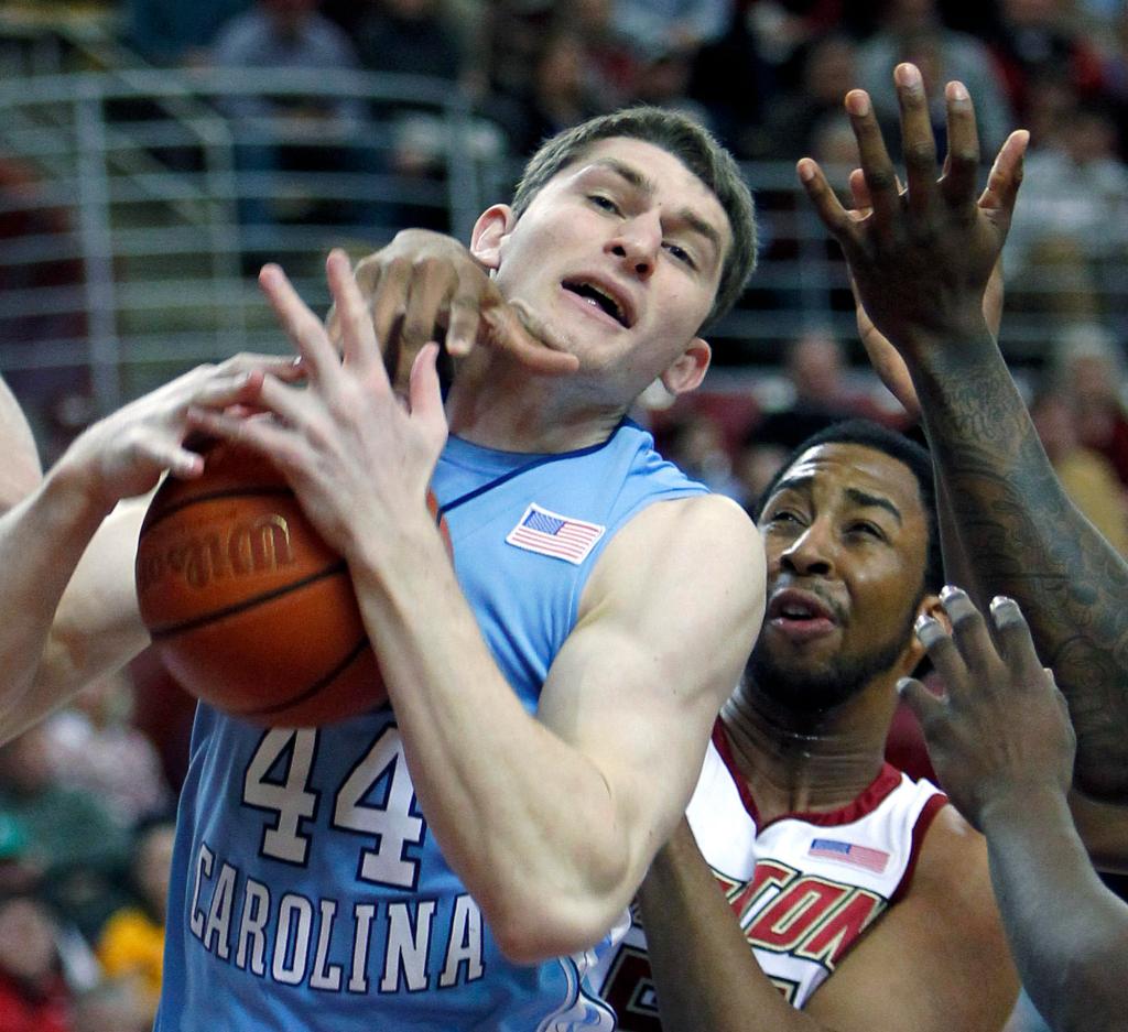 Photos by The Associated Press Tyler Zeller of North Carolina grabs a rebound in front of Boston College’s Josh Southern during the Eagles’71-67 victory Saturday at Boston, the Tar Heels’ ninth loss in their last 11 games.