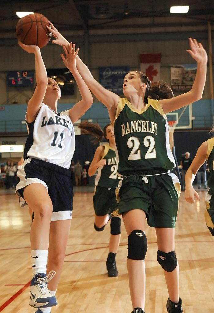 Staff photo by Joe Phelan Rangeley sophomore forward Emily Carrier, right (22) blocks a shot by Greenville senior McKenna Peat Saturday during the Western Maine Class D regional game at the Augusta Civic Center.