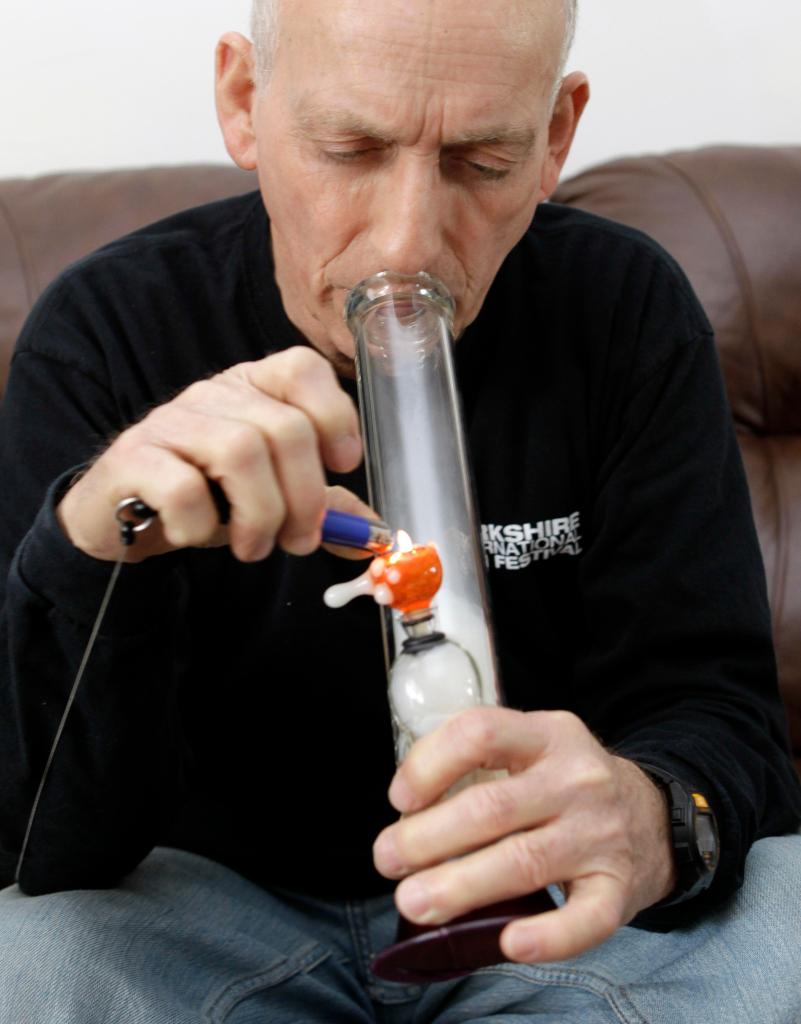 Perry Parks, 67, takes a puff of marijuana at his home in North Carolina. The retired Army pilot suffered crippling pain from degenerative disc disease and arthritis before turning to the drug. “I realized I could get by without (prescription painkillers),” he says. “I am essentially pain-free.”