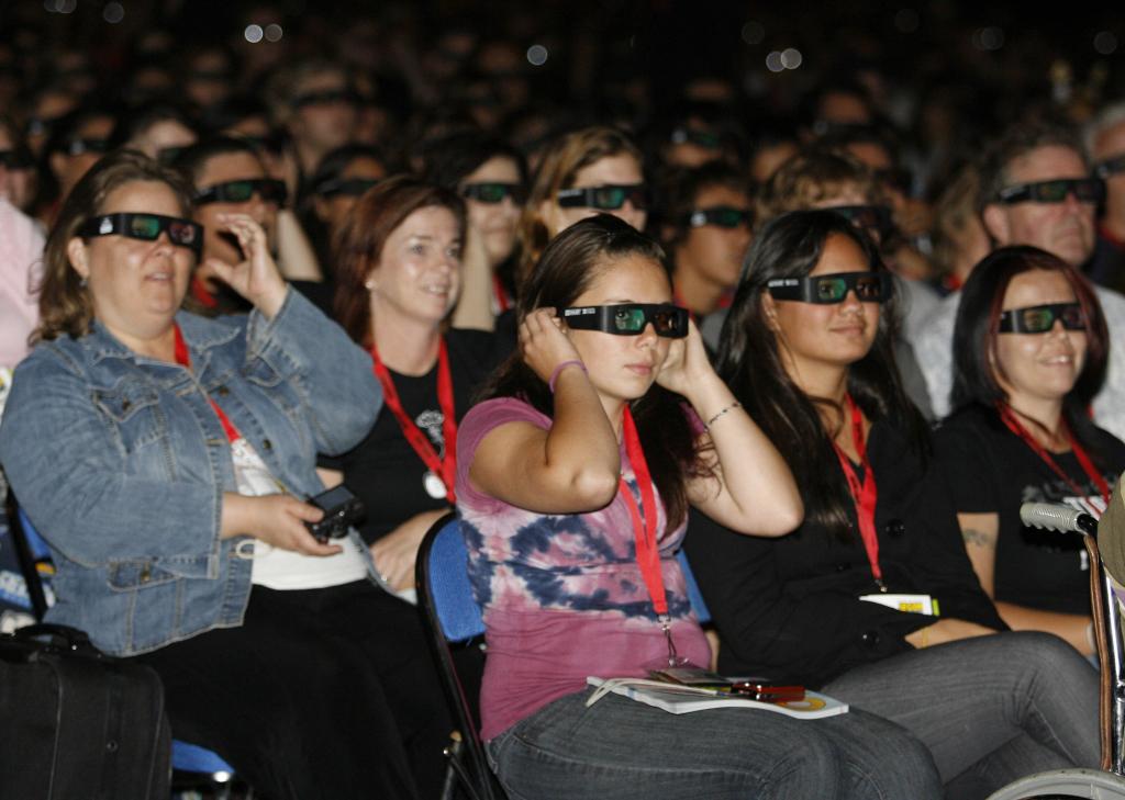 Fans wear 3-D glasses for the movie “Alice in Wonderland” at the Comic-Con International 2009 convention held in July in San Diego. Movies in 3-D are becoming such big moneymakers that studios are cramming them on short runs into theaters.