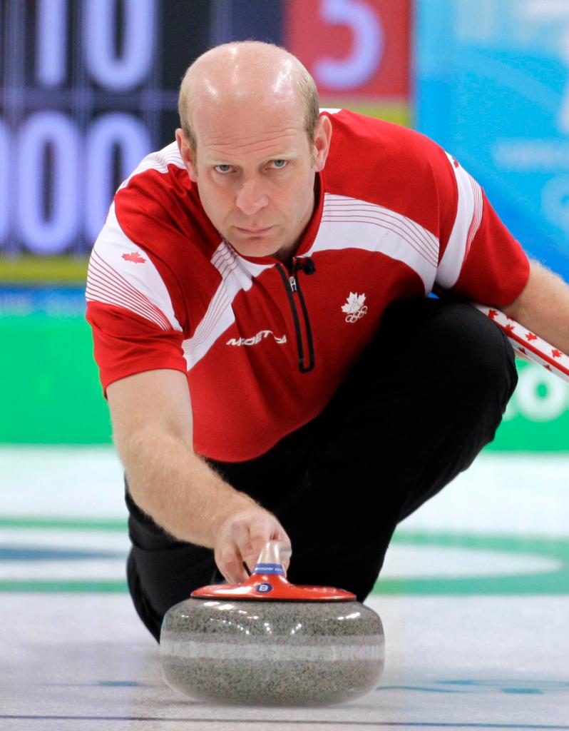 Canada skip Kevin Martin sends the stone along the ice during a match against the United States. Canada remained unbeaten with a 7-2 victory Monday.
