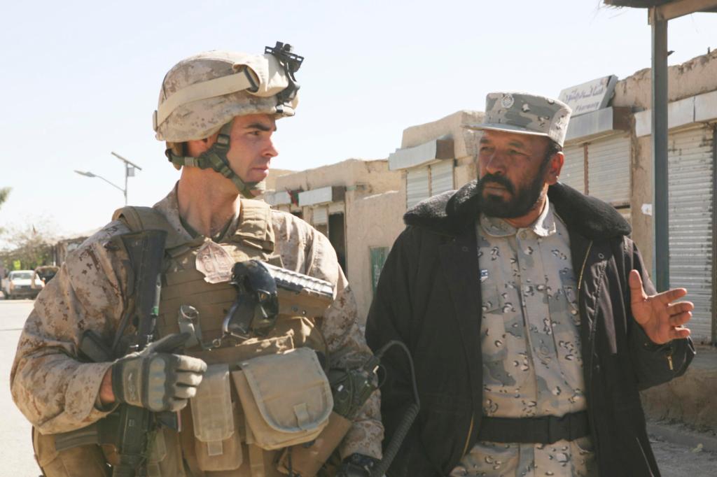 Marine Lt. Col. John E. McDonough walks with Lt. Col. Gul Aqa Amiry, the border police commander, in Garmsir, Afghanistan, after a security consultation at the district governor’s compound in November. McDonough, a Portland High graduate, served in Iraq in 2003 during Operation Iraqi Freedom and later was awarded a Bronze Star.