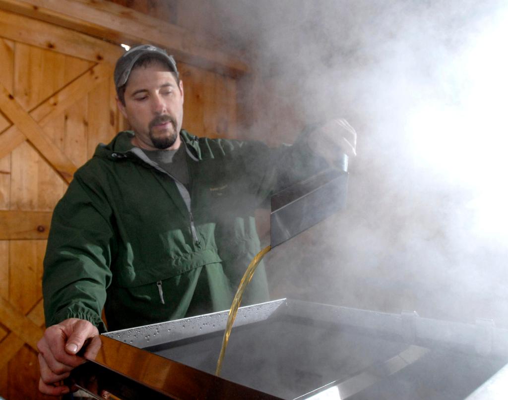 Keith Harris of Harris Farm in Dayton monitors sap boiling into maple syrup Tuesday. He has already produced about 10 percent of what he expects to make this season at a time when the taps on his 525 maple trees are usually still dry. There is concern the sap run will be over before Maine Maple Sunday on March 28.