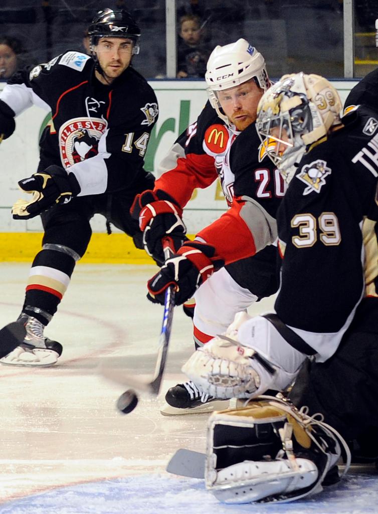 Jeff Cowan of the Portland Pirates attempts to slip the puck past Brad Thiessen, the goalie for the Wilkes-Barre/Scranton Penguins, in the Pirates’ 2-1 victory Tuesday night at the Cumberland County Civic Center.