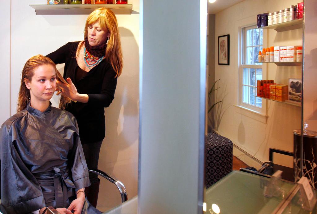 Sheryl Miller-Barrett has worked in top hair salons in New York and Las Vegas. She opened Fringe Hair Art in Kennebunkport last year. Here she works with client Shana Aldrich in her salon.