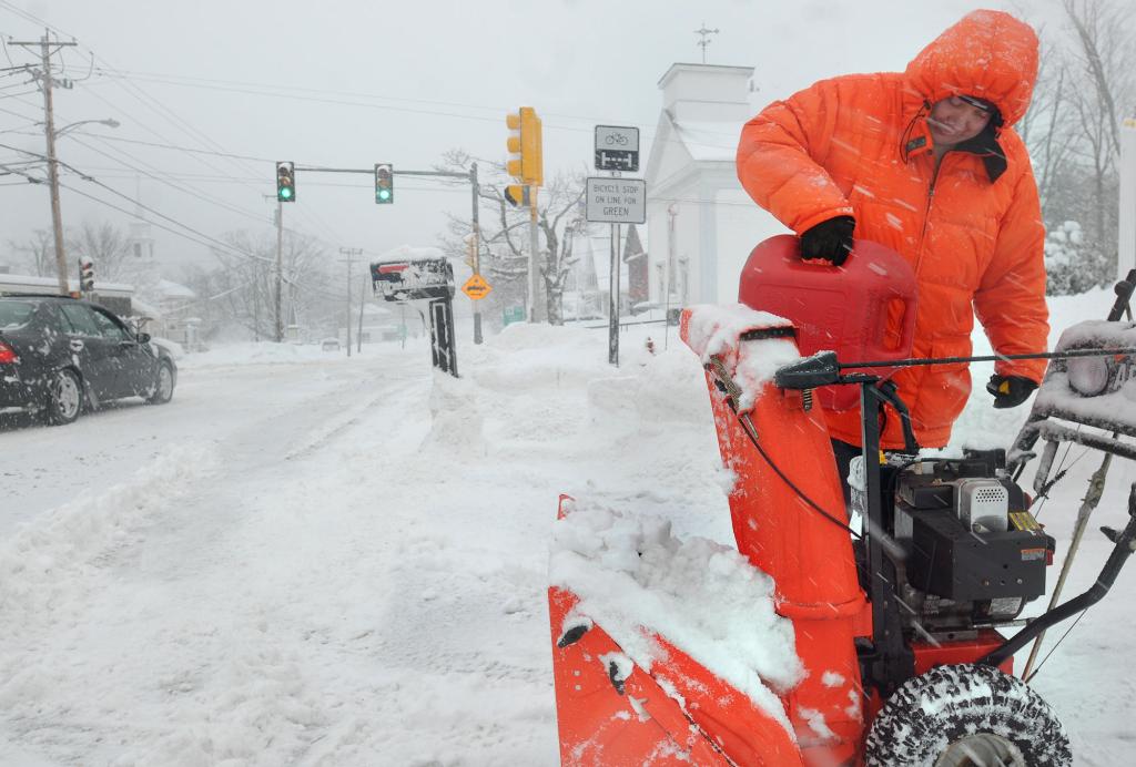 Walter Taylor refills his snowblower in Westminster, Mass., on Wednesday. As another storm approaches, up to 2 feet of snow are possible in parts of New York and Vermont.