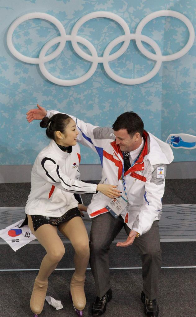 Kim Yu-na, left, with her coach, Brian Orser, has the inside track for the gold medal after setting a world record in the short program.