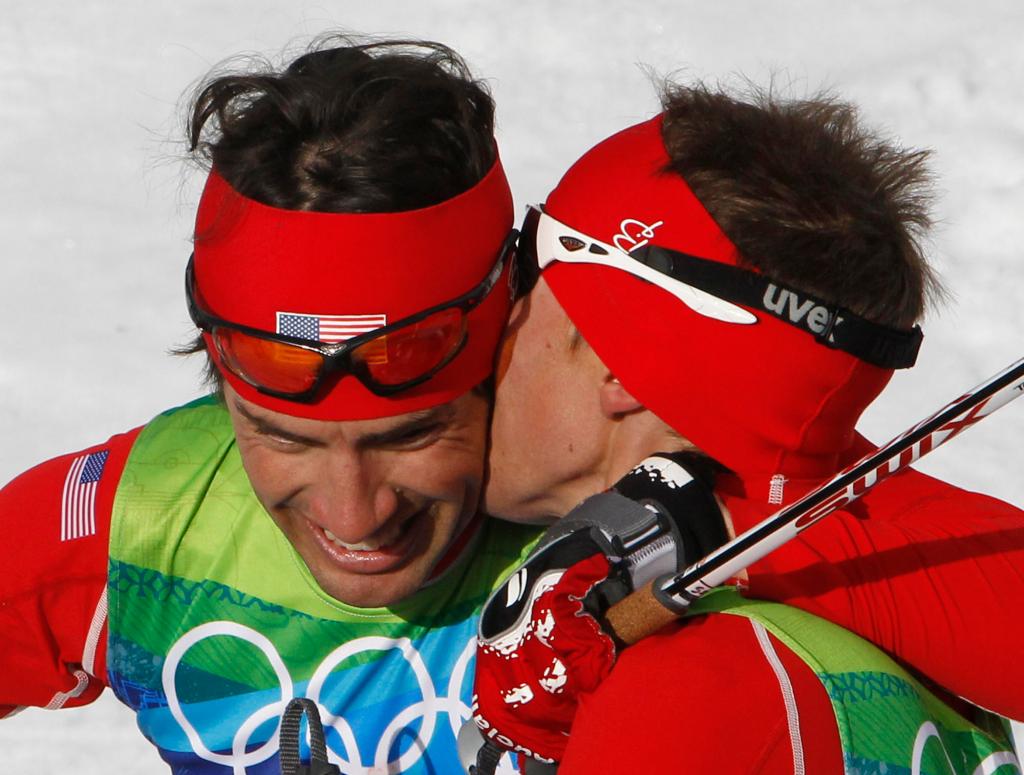 United States' gold medal winner Bill Demong, right, kisses United States' silver medalist Johnny Spillane during the Men's Nordic Combined Individual event from the large hill at the Vancouver 2010 Olympics in Whistler, British Columbia, Canada, Thursday, Feb. 25, 2010. (AP Photo/Matthias Schrader)