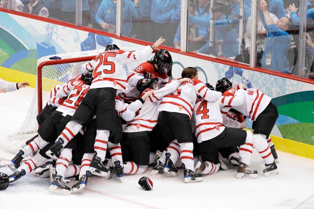 Canadian players celebrate after they beat the USA 2-0 to win the women's gold medal ice hockey game at the Vancouver 2010 Olympics in Vancouver, British Columbia, Thursday, Feb. 25, 2010. (AP Photo/Chris O'Meara)
