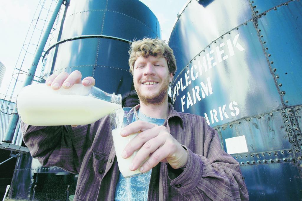 John Clark pours raw milk into a glass at Applecheek Farm in Hyde Park, Vt. The sale of raw milk is prohibited in 23 states, and seven other states are considering legislation to change laws governing raw milk.